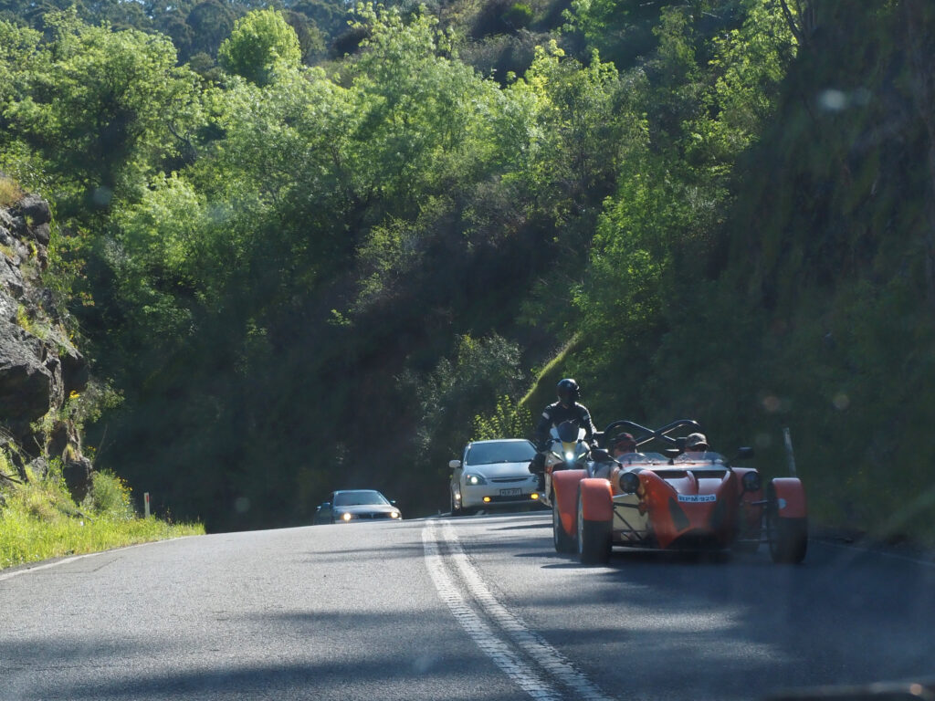 some kind of orange race car thingy, I don't even know what it is, on a twisty road in Adelaide's hills